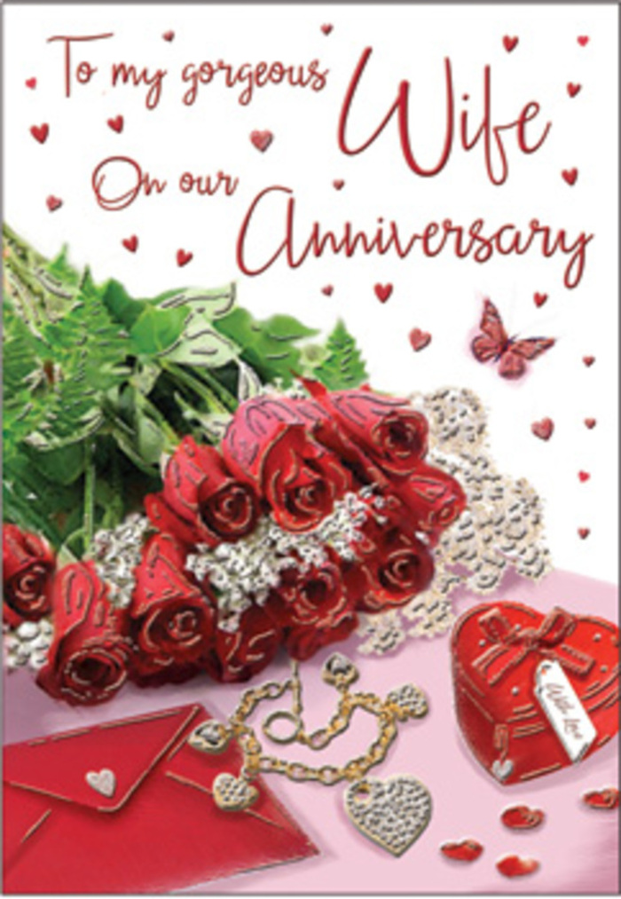 A rich, romantic tableau is captured in this anniversary card image, as if laid out on a dressing table in a Surrey cottage before an evening celebration. At the centre, a bouquet of classic red roses commands attention, each bloom generously full, the petals layered in deep crimson folds that suggest both luxury and comfort. The roses are elegantly wrapped and intertwined with lush green foliage, reminiscent of the verdant hedgerows and woodland paths found across the Surrey Hills. The surrounding details are carefully chosen to tell a story of shared years and treasured moments: a jewellery set with a polished metallic finish glimmers softly, while a vivid red gift box adds a focal splash of colour that echoes the roses. Subtle heart motifs and delicate lace-like textures accent the composition, catching the light with a whisper of sheen. The anniversary message, written in a graceful script, sweeps across the card, its curves mirroring the organic shapes of petals and ribbon. The lighting is gentle and flattering, casting only the softest shadows so that the richness of the reds and greens remains clear and inviting. The textures create a sensory tapestry-the imagined coolness of metal, the smoothness of card, the velvety feel of each rose, and the suggestion of a lingering floral scent. Everything has been arranged with the practiced skill of a local Surrey florist, someone who frequently prepares thoughtful gifts for couples celebrating milestones in towns from Dorking to Camberley. The result is a warm, embracing design that feels as enduring as the love it honours, perfect for marking an anniversary with quiet grace.